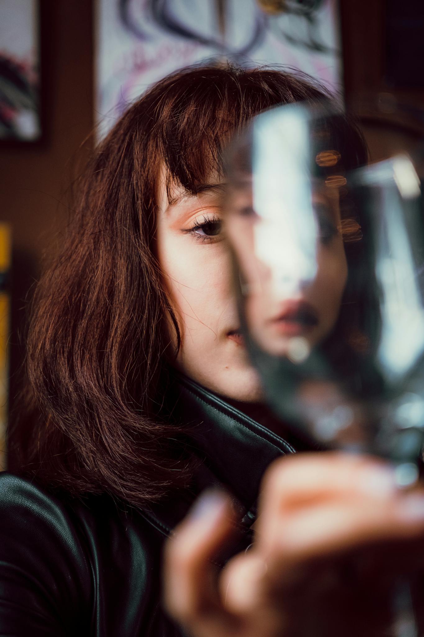 A captivating portrait of a woman viewed through a blurred glass, creating a mysterious and modern artistic effect.
