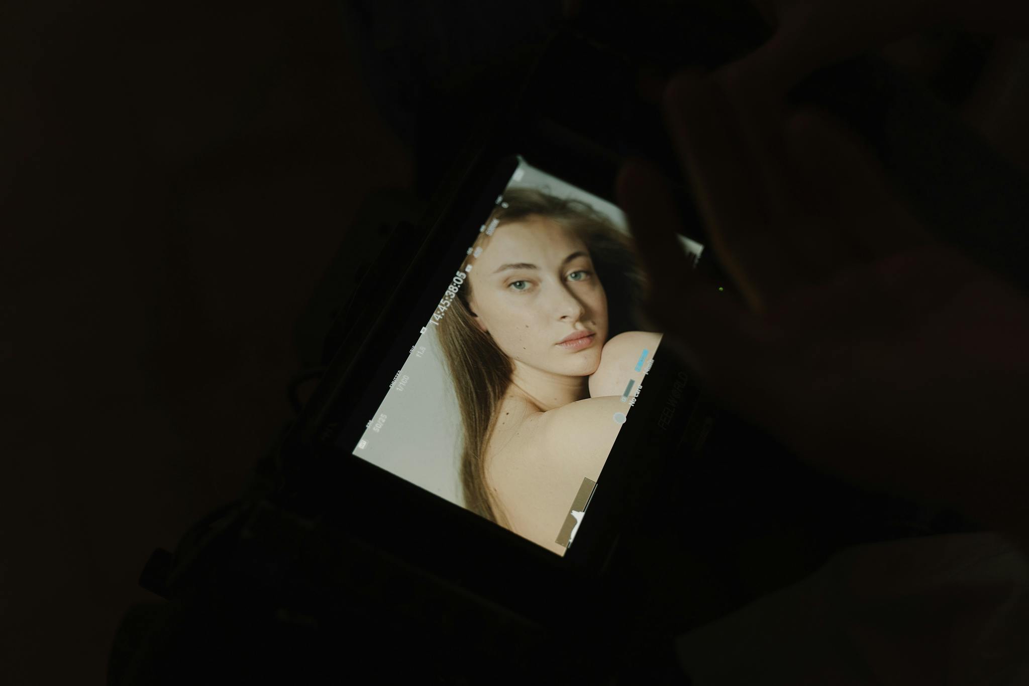 A photographer's screen displaying an elegant portrait of a woman, captured indoors.