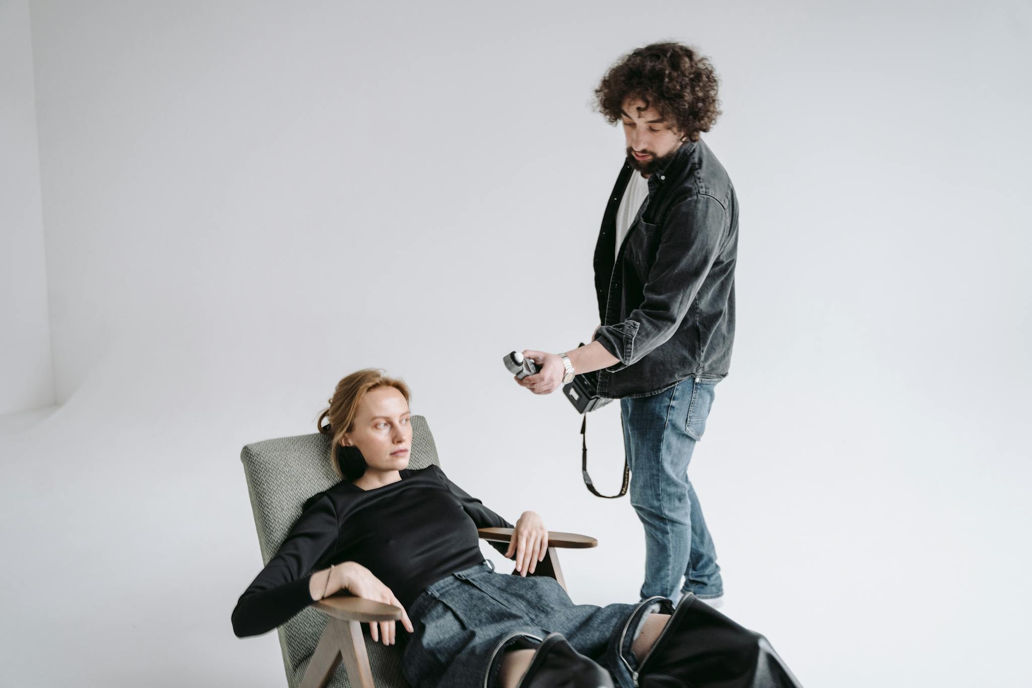 Photographer instructing model during a professional studio photoshoot.