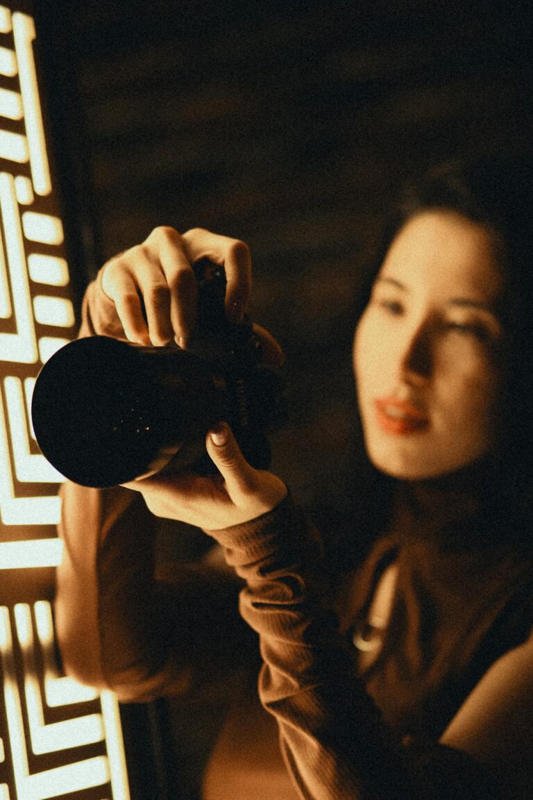Stylish woman capturing a moment with DSLR camera in warm light.